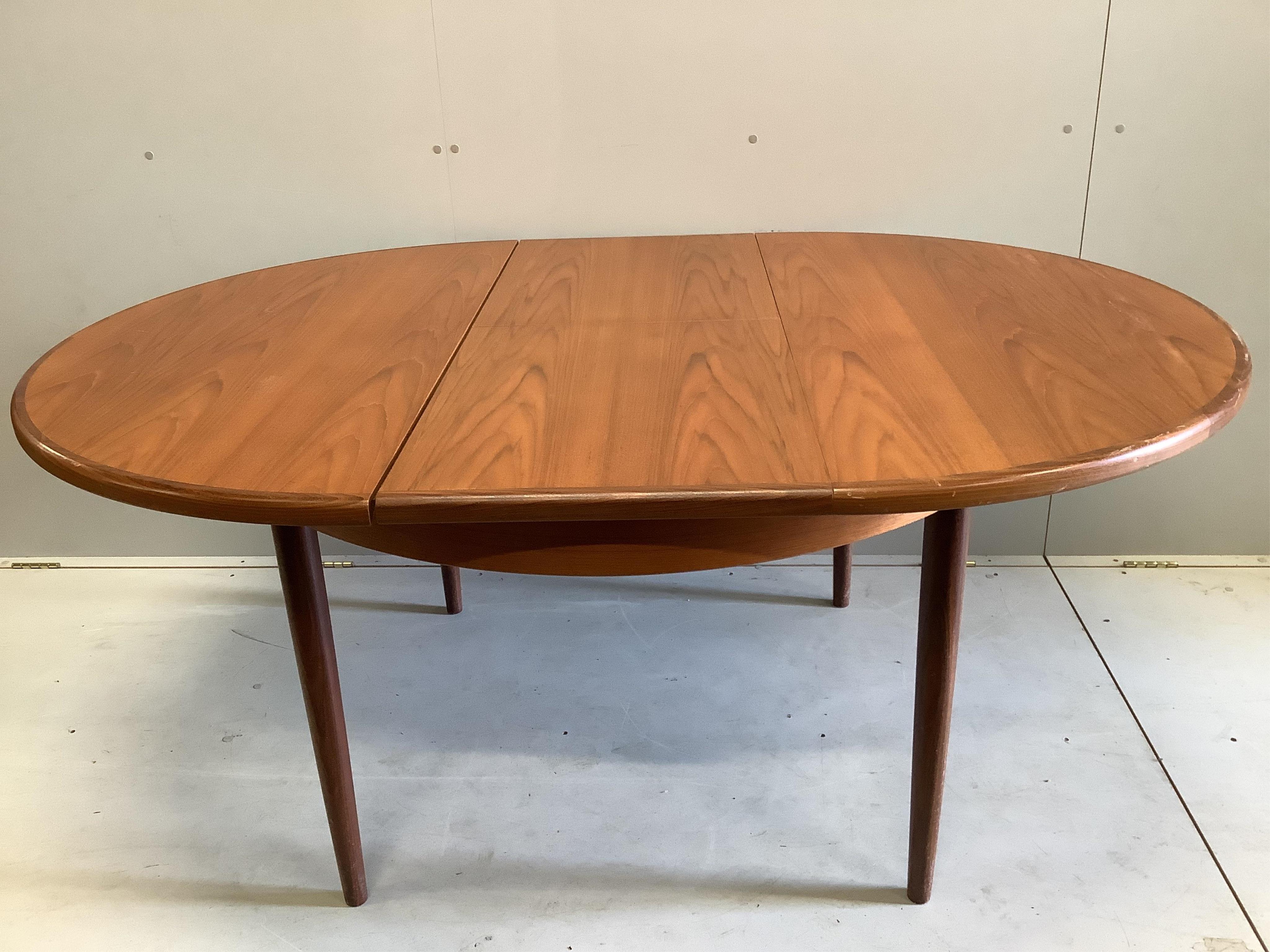 A mid century G Plan teak circular extending dining table, diameter 122cm, four chairs and sideboard, width 138cm, depth 44cm, height 72cm and a nest of tables. Condition - fair